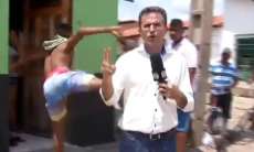 Jornalista leva 'voadora' de morador ao vivo. Veja o v&iacute;deo